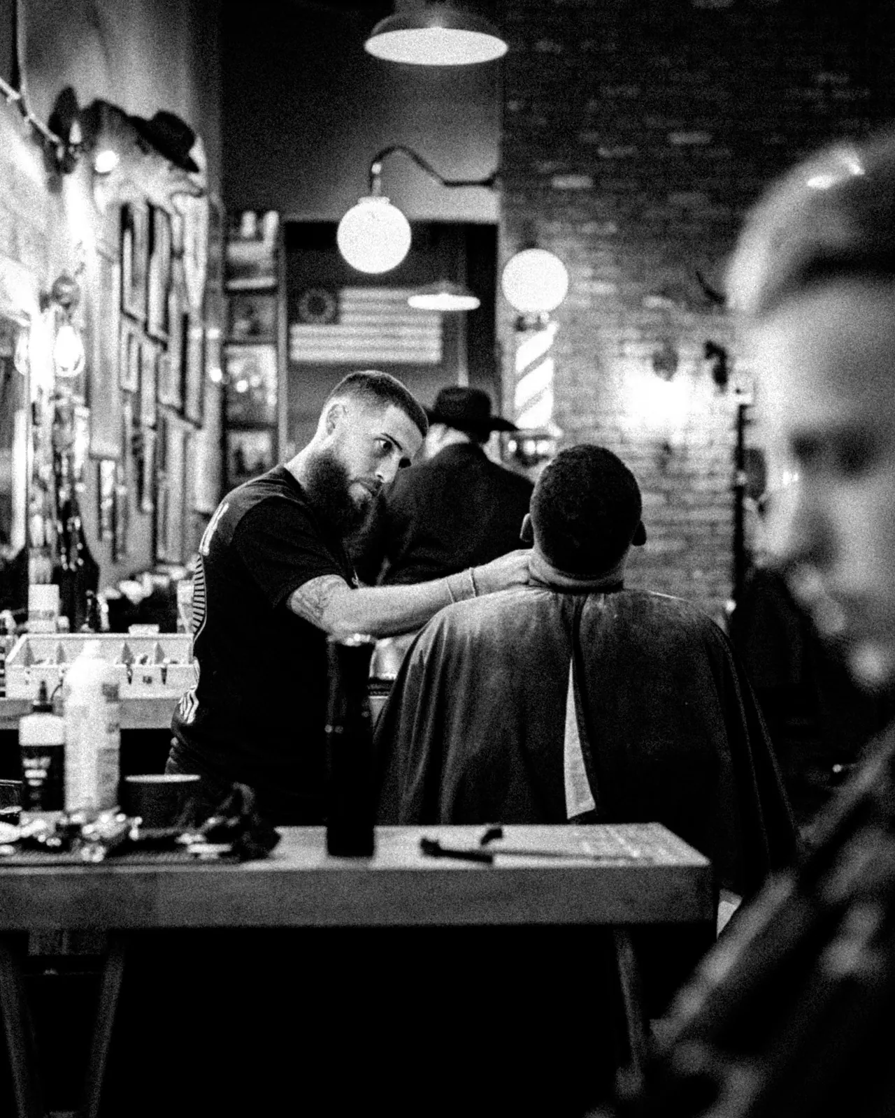 A client and barber inside Outlaw Barber Company Goose Creek