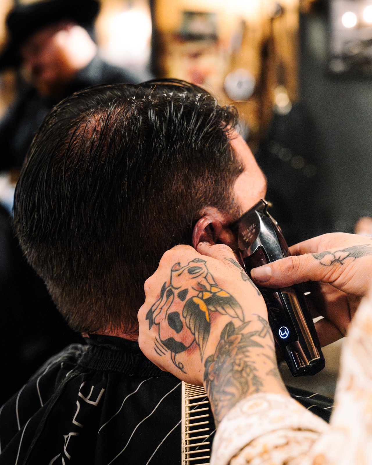 Barber creating a fade haircut at Outlaw Barber Company in Goose Creek, SC