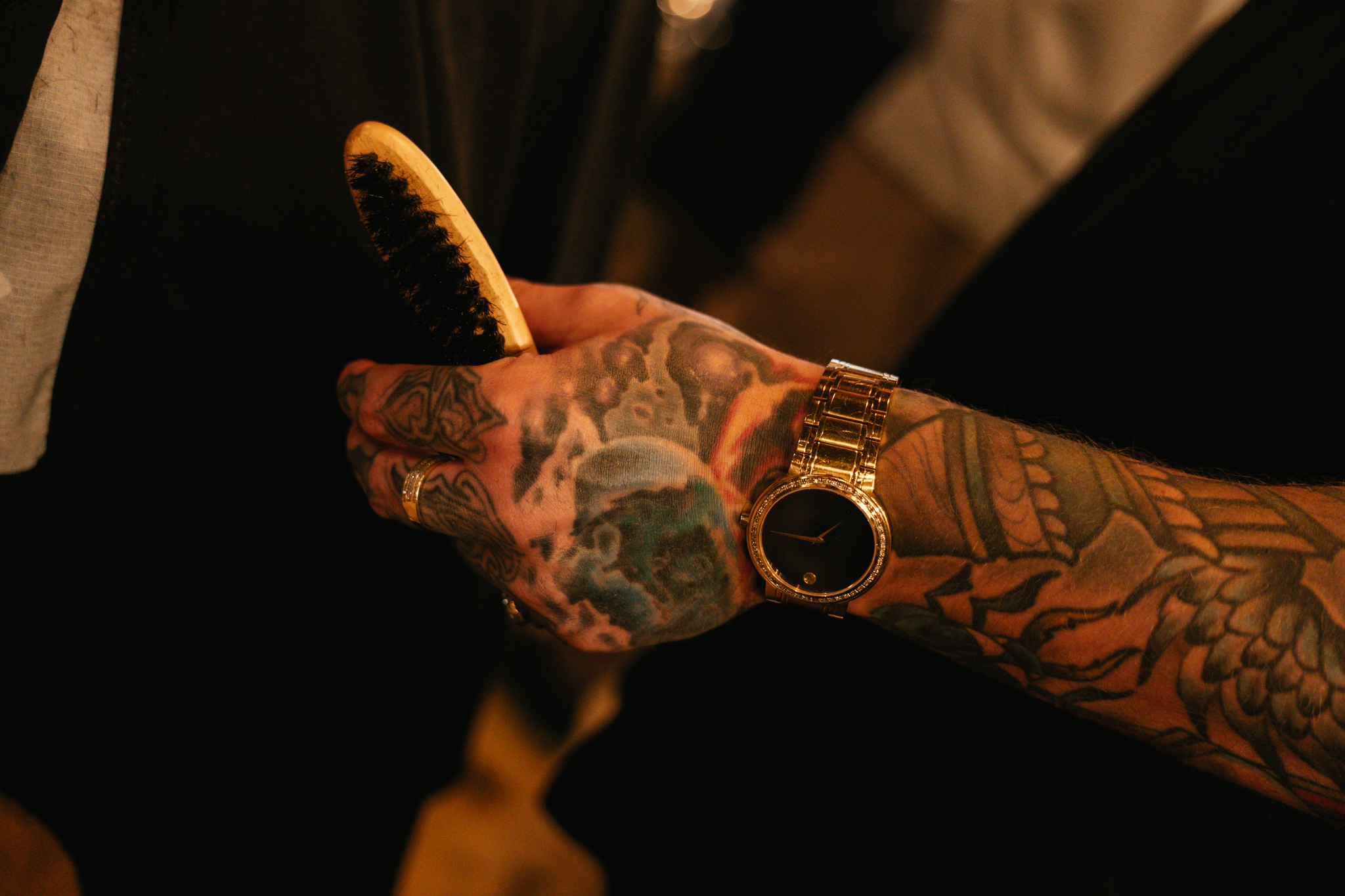 A barber grooming a beard at Outlaw Barber Company